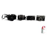 several cameras are lined up in a row on a white surface