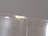 a close up of a piece of metal with a yellow substance on it