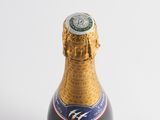 a close up of a bottle of champagne on a white surface