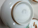 three plates and a teapot sitting on a table