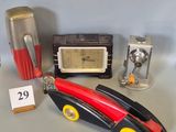 a toy car with a clock and other items on a table