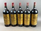 six bottles of wine lined up in a row on a table