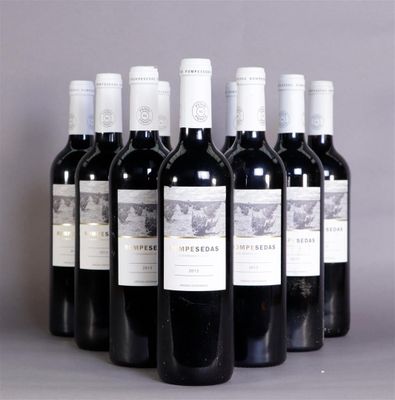 six bottles of wine are lined up in a row on a table