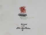 an old porcelain plate with a red and white design on it