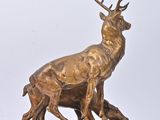 bronze sculpture of a stag and a baby stag on a rock