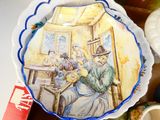 a plate with a painting on it sitting on a table