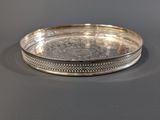 a silver plate with a decorative design on the rim