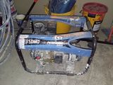 a small generator that is sitting in the garage