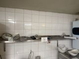 a small kitchen with a refrigerator and a sink