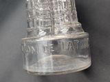 a clear glass bottle with a clock on top of it
