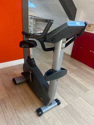 an image of a stationary exercise bike in a room with a red wall