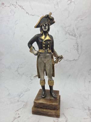 statue of a man dressed in a pirate costume holding a sword