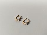 a pair of gold earrings with pearls on them