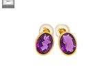 an image of a pair of earrings with a purple stone