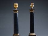 a pair of black and gold table lamps