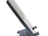 a cell phone sitting on a stand on a white surface