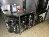 pots and pans sitting on a stainless steel counter