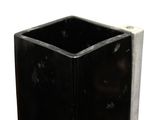 a black vase that is sitting on a white surface