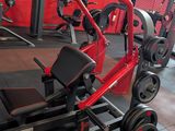 a gym with a row of machines in the middle of the room