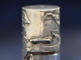 a close up of a silver ring with birds on it