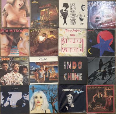 many different album covers on the wall of this room