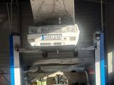 a car that is sitting on a lift in a garage