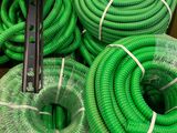 green hoses are stacked on top of each other in a box