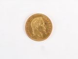 an old gold coin on a white surface with a white background