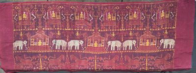 an image of a red cloth with elephants on it sitting on a chair