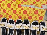 six pairs of white and black slippers with gold chains on them