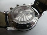 a close up of a watch on a white surface