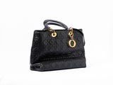 black leather handbag with gold hardware and chain handles on a white background