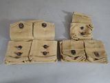 three pairs of tan pants with buttons on them sitting on a table