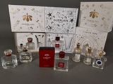 several bottles of perfume are sitting on a table in front of a box