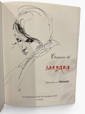 an open book with a drawing of a woman ' s face on it