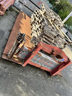 a pile of pallets on the ground next to a building