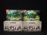 two boxes of warhammer miniatures sit side by side on a black surface