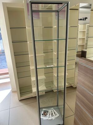 a glass display case in the middle of a room