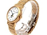 a gold wrist watch with a white dial on it
