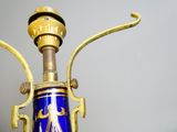 a blue vase with a gold decoration on it