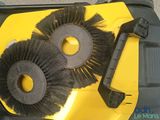 two brushes that are sitting on top of a yellow box