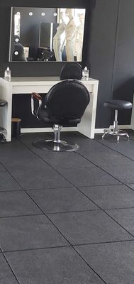 a large room with chairs and mirrors in it