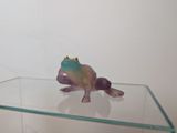 a glass table with a figurine of a frog on top of it
