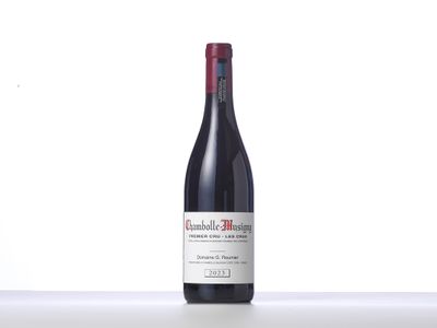 a bottle of red wine sitting on top of a counter