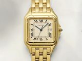 a close up of a gold wrist watch with roman numerals
