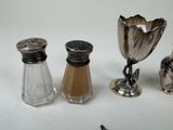 three salt and pepper shakers on the table