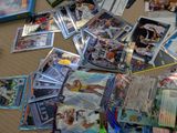 pile of baseball cards and cards on a table in a room