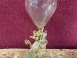 a glass vase that is sitting on a table