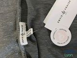 the label of a women ' s dress is attached to the back of the dress