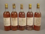 six bottles of wine are lined up in a row